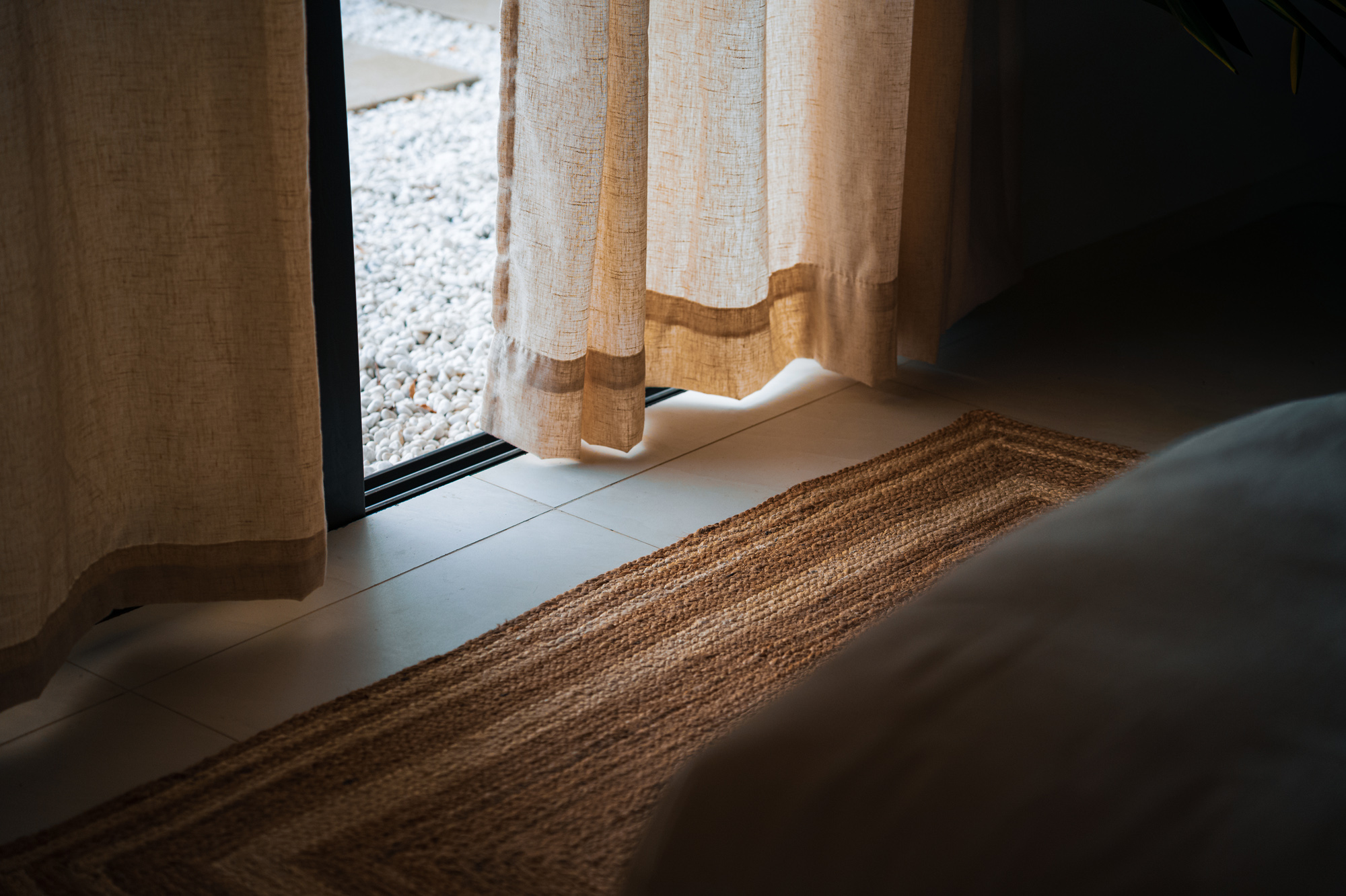 Serena villa interior with jute rug and curtain detail