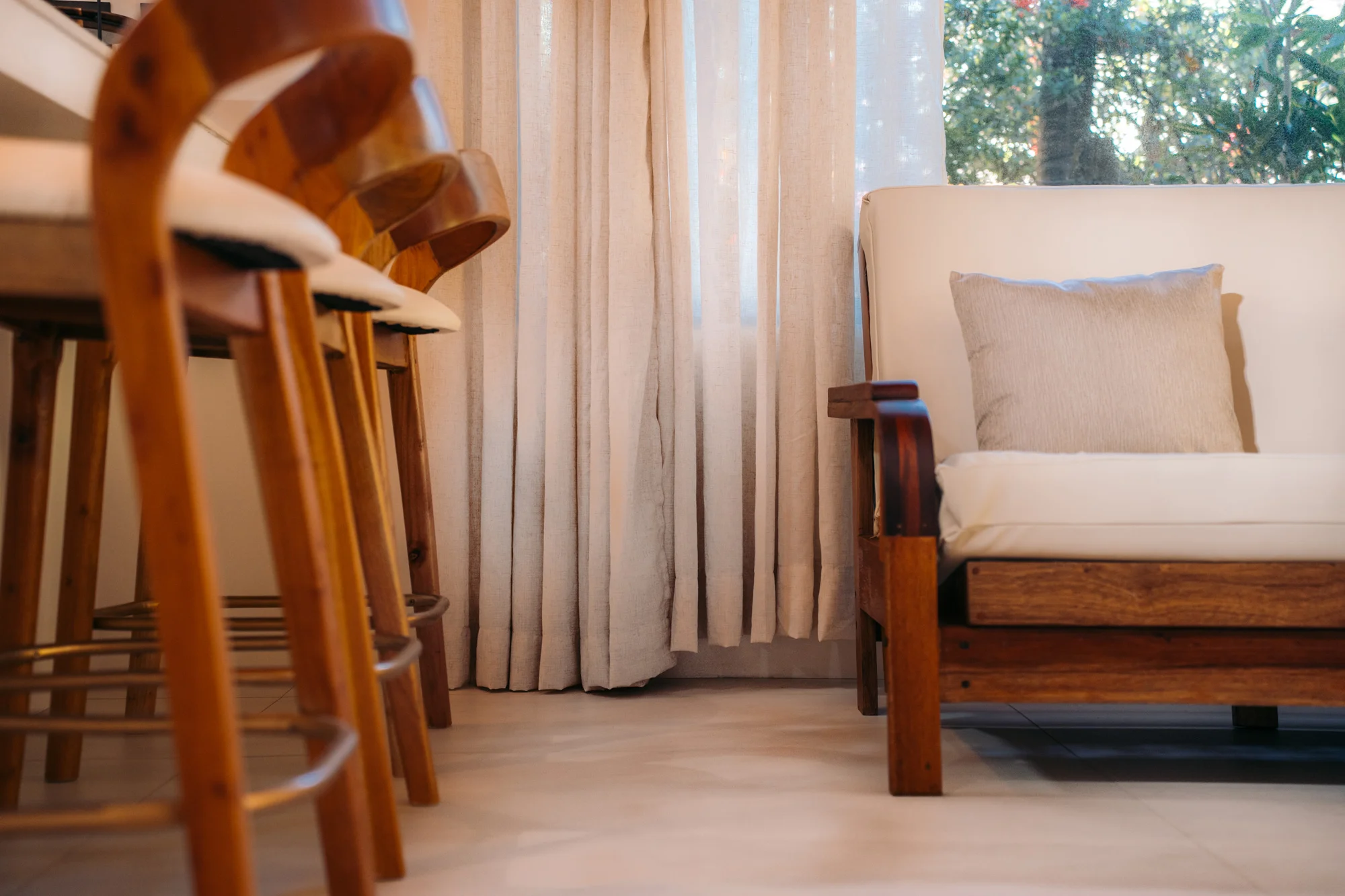 Serena villa living room with stools, curtain and sofa